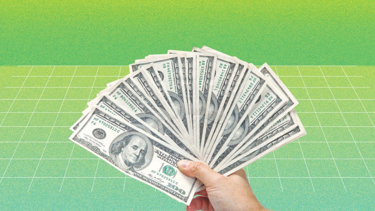 A hand holding dollar bills